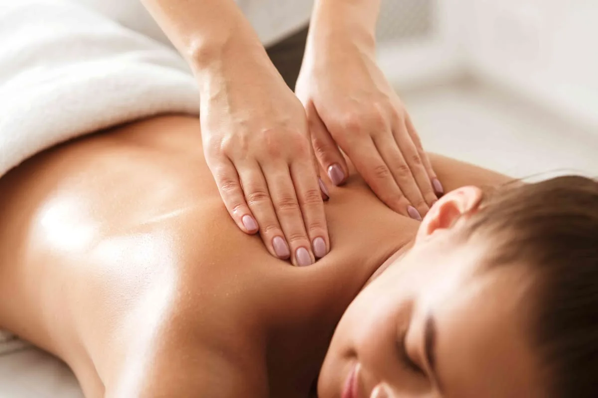 Swedish massage in St. Barths — therapist performing back massage on a guest in a private villa
